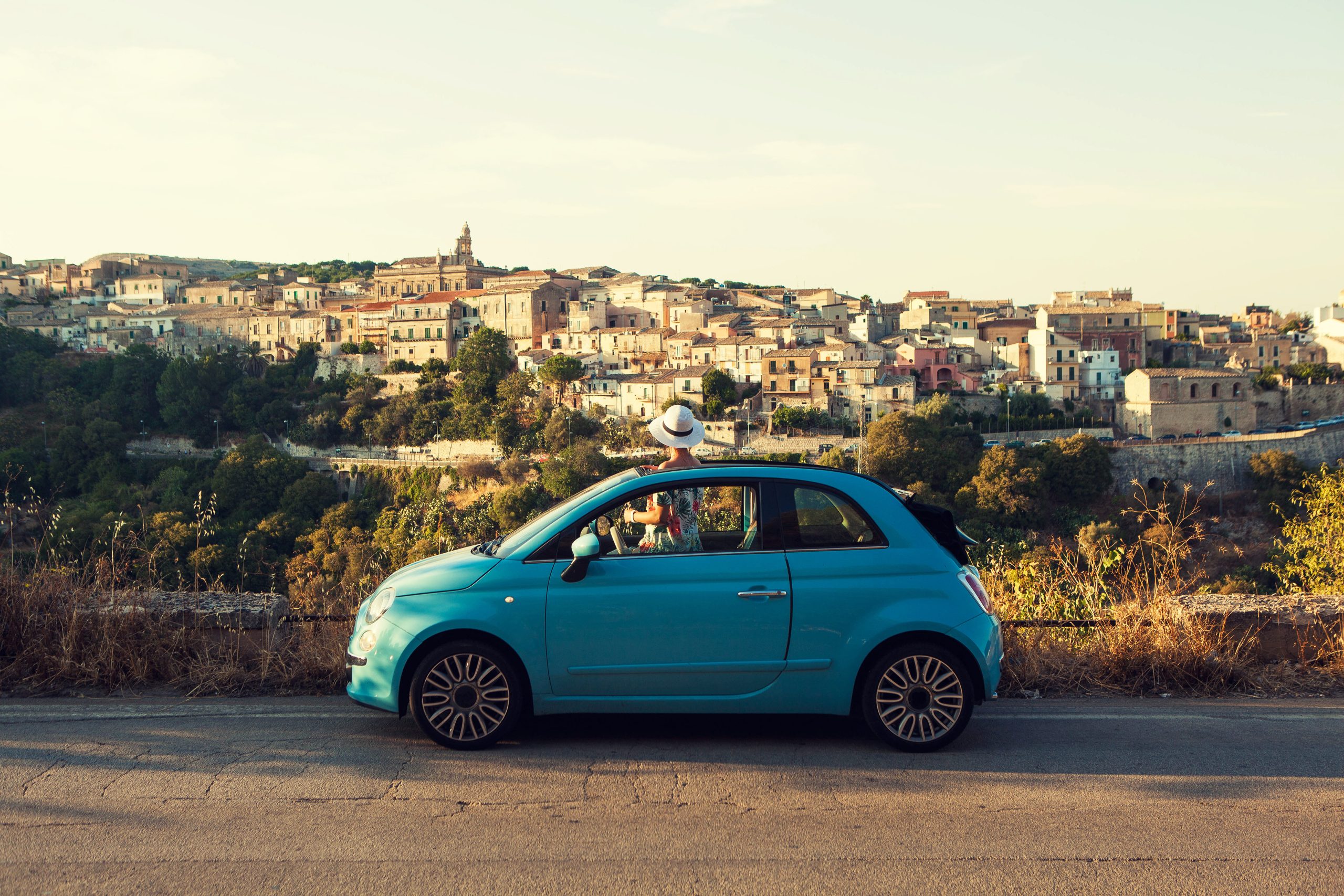 The girl looking at Ragusa skyline from the car, Italy.