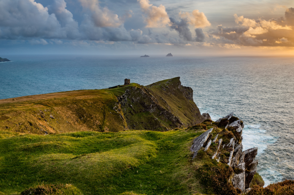 a viewpoint from bray head on valentia island in the ring of kerry in the south west coast of ireland during an autumn sunset showing the skellig islands and watchtower